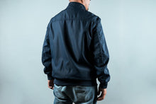 Load image into Gallery viewer, Man wearing a navy sports jacket from behind
